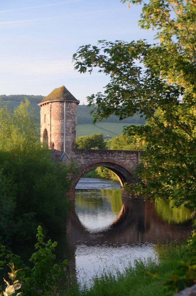Bridge reflected in the river with defensive tower and gate into Monmouth on the Offa's Dyke Path