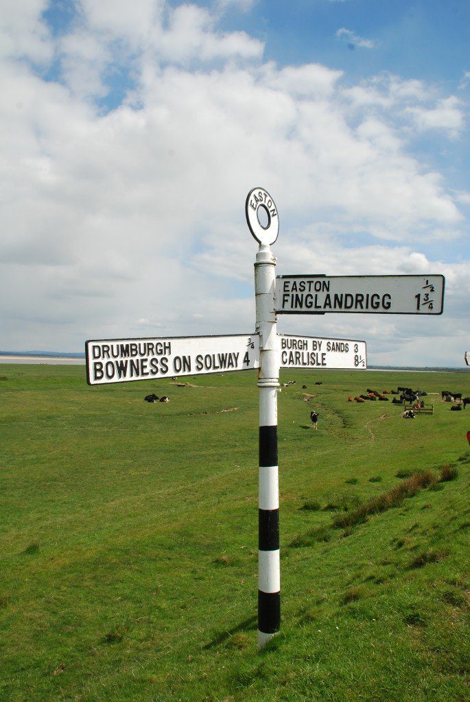 Old black-and-white road sign by the Solway on the Hadrian's Wall Path.