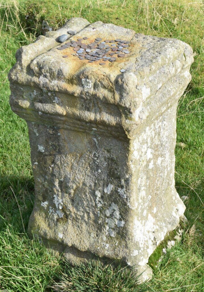 Stone Roman altar with money on top