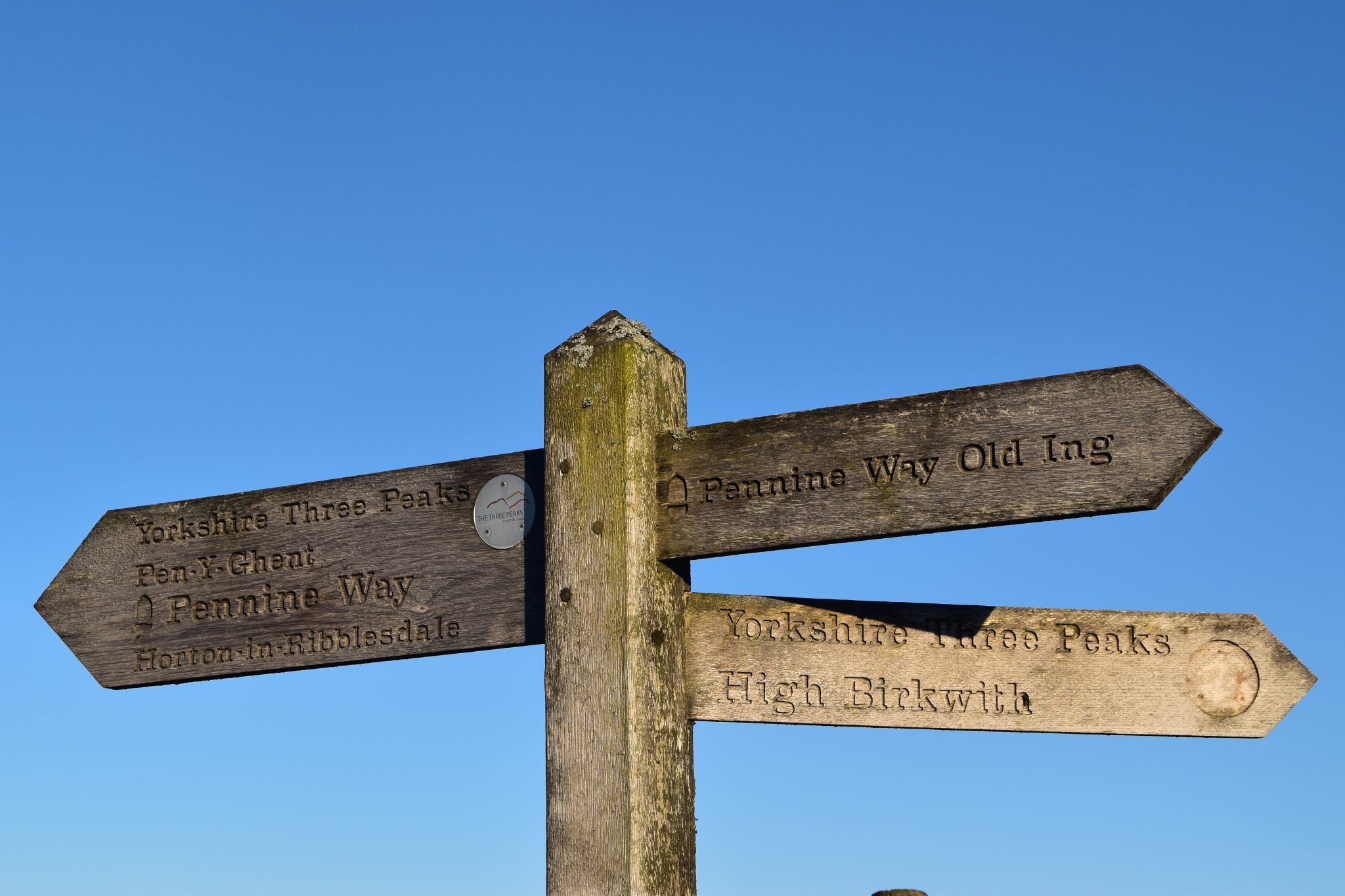 Old wooden Pennine Way sign pointing to Old Ing, Horton in Ribblesdale and High Birkwith