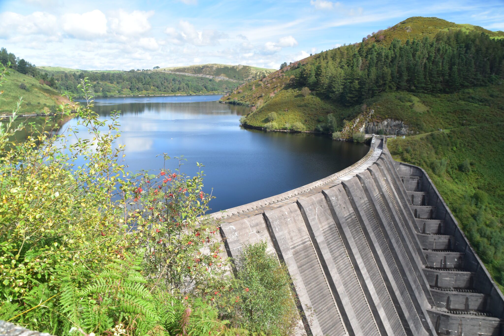 Wall of Clewydog Dam with reservoir behind it