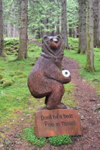 Sculpture of bear holding toilet roll