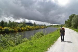 Hiker walking by the Caledonian Canal on the Great Glen Way